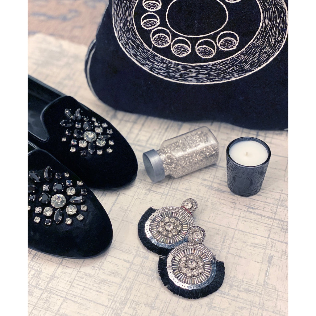 Statement silver earrings with black fringe, sparkling stones, and a unique "UGH" patch, perfect for adding a touch of attitude to your look.