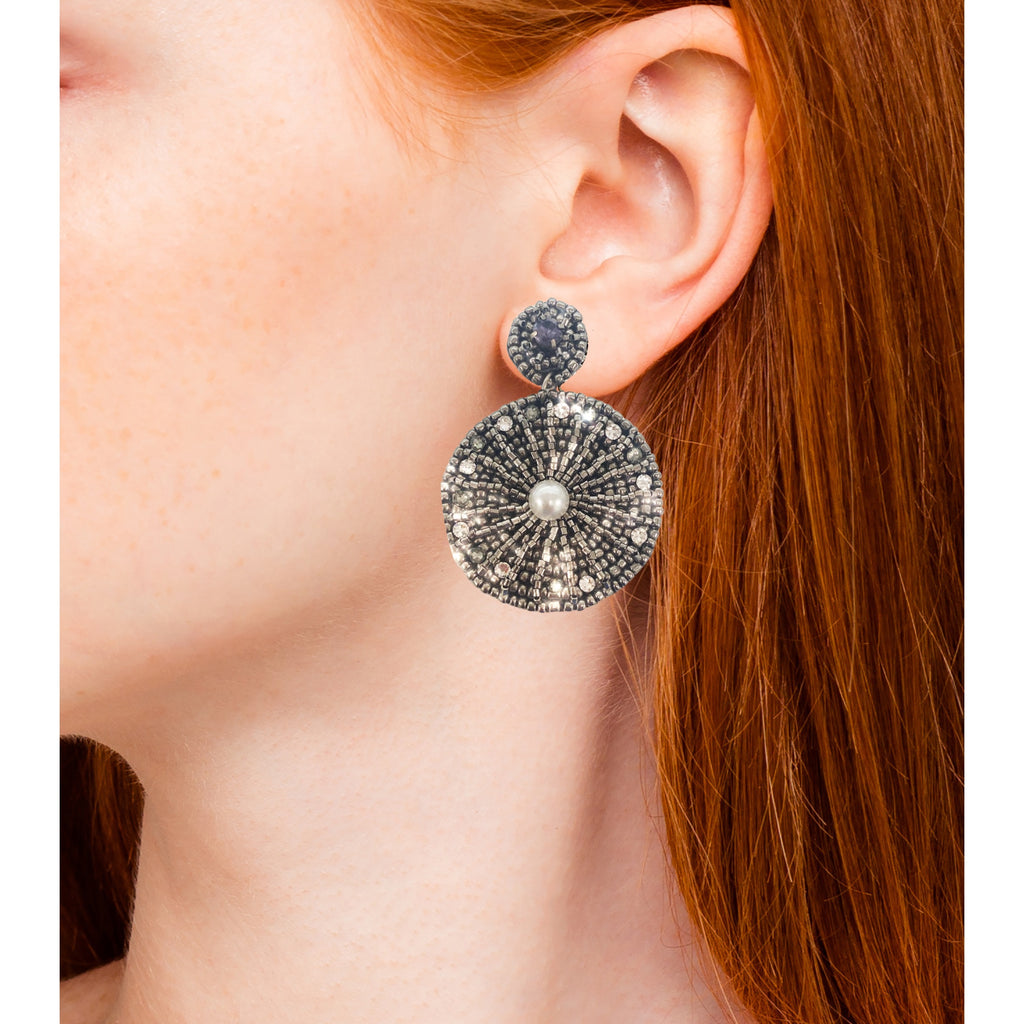 Statement silver earrings with bold starburst pattern and fun "Danger" and cactus patches.