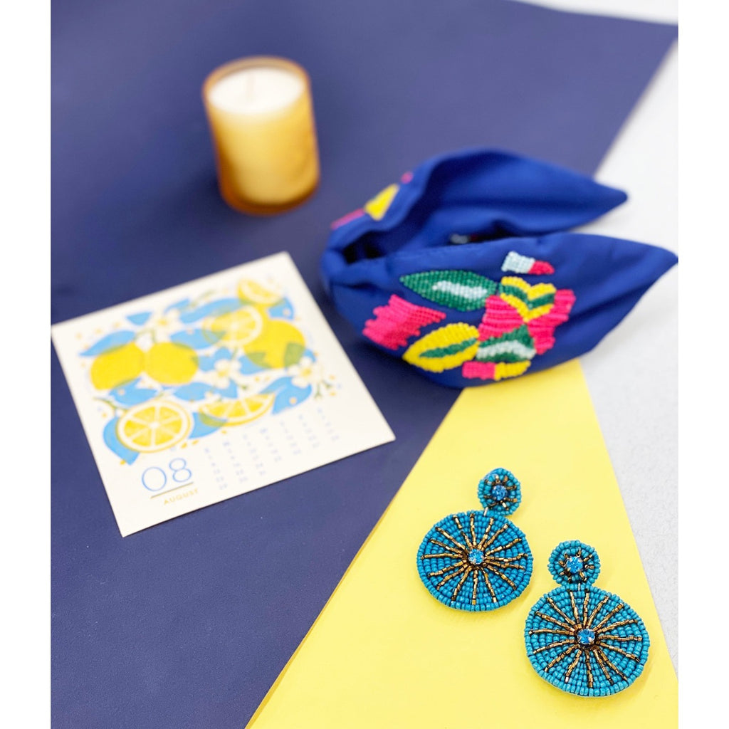 Sparkly aqua earrings featuring a starburst design and a "Bad Bitch" patch, perfect for making a statement.