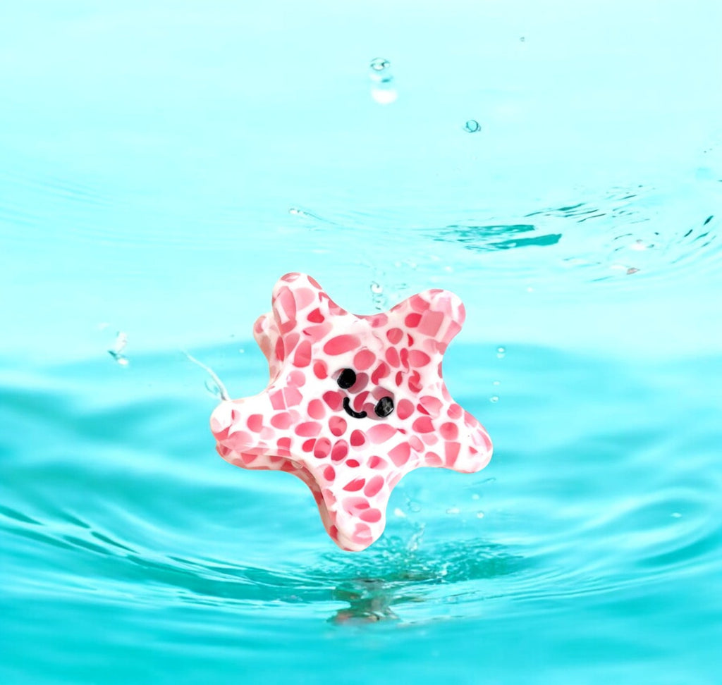 Cute starfish design hair clip in pink, great for adding a playful touch to hairstyles.