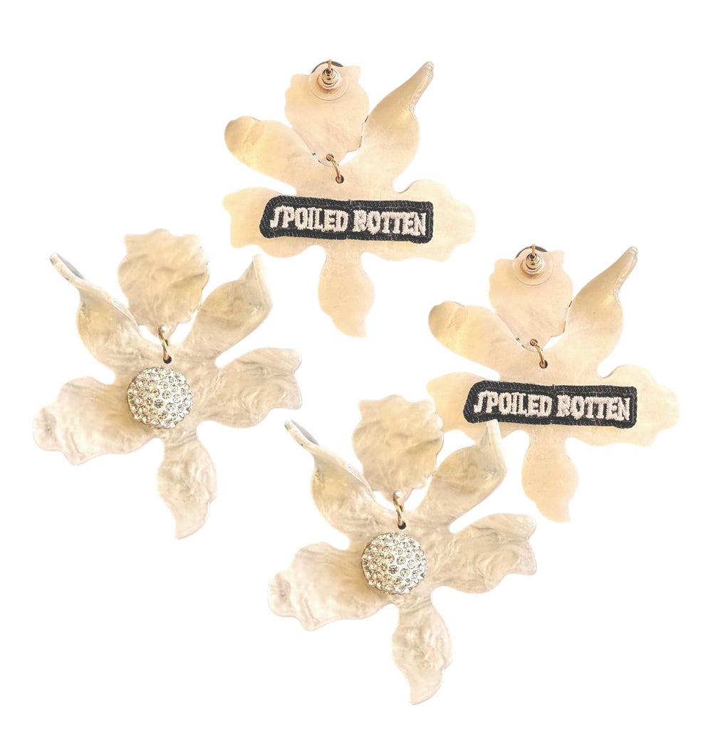 Elegant floral-inspired earrings with a modern edge, featuring textured ivory petals, sparkling crystal centers, and a cheeky 'Spoiled Rotten' detail on the back—perfect for making a bold and sophisticated statement.