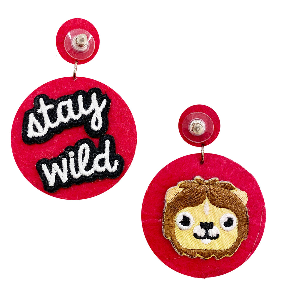 Eye-catching fuchsia earrings with a starburst design, complemented by unique "Stay Wild" and lion patches.