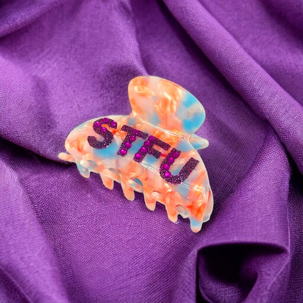 Edgy "STFU" hair clip adorned with sparkling rhinestones, perfect for adding a touch of sass to any outfit.