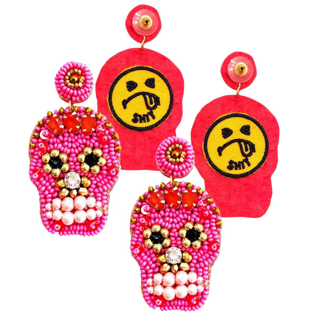 Vivid and edgy sugar skull earrings featuring intricate pink beadwork, gold accents, and playful embroidered backs with a cheeky 'ugh' emoji design—perfect for bold, statement-making style.