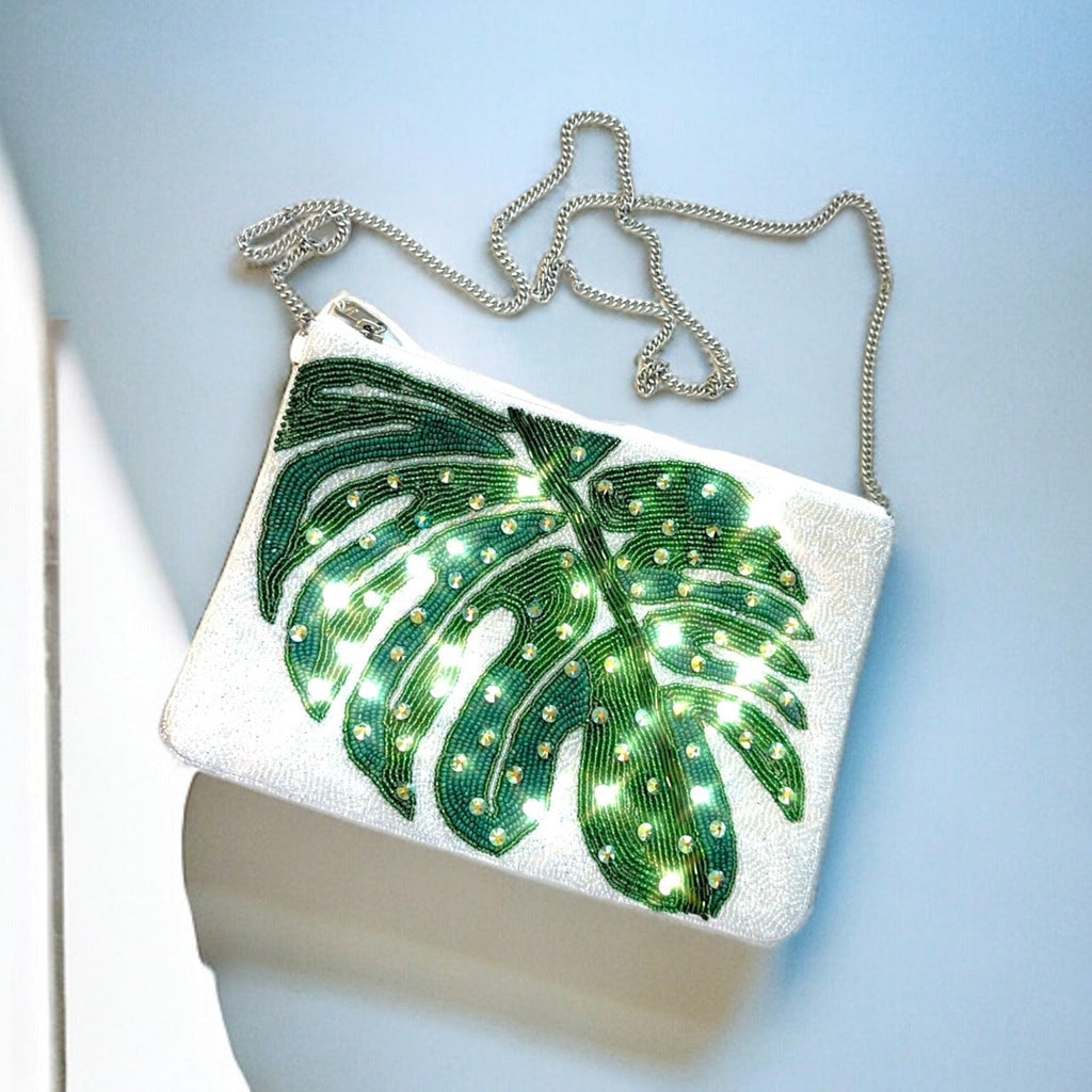 Tropical leaf beaded handbag with intricate detailing and vibrant colors, perfect for beachy summer vibes.
