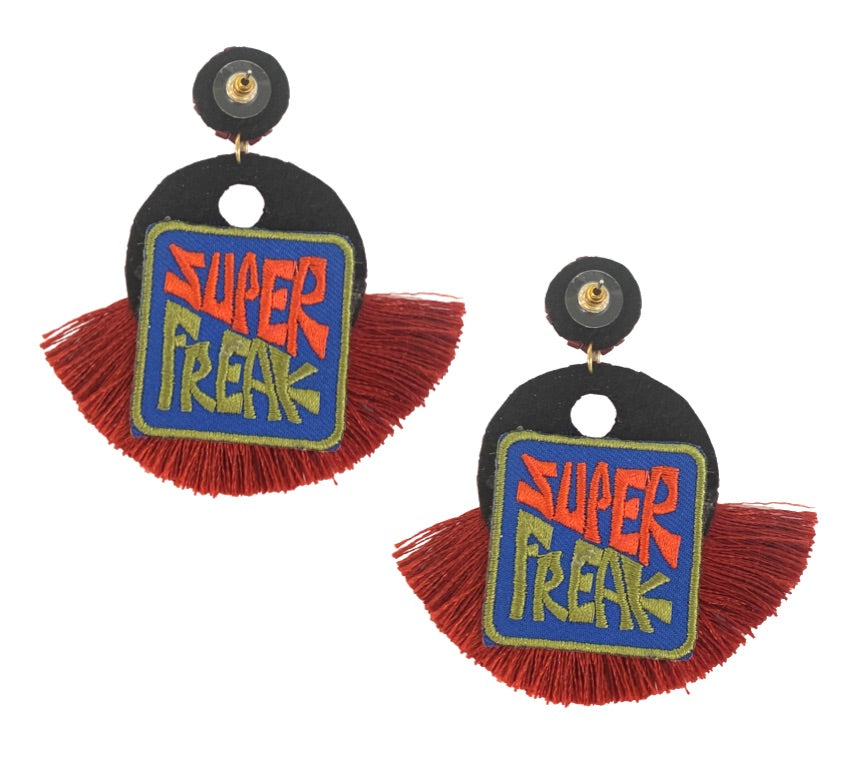 Bold burgundy earrings with a Super Freak patch and tassel fringe, designed for fashion-forward statement style.