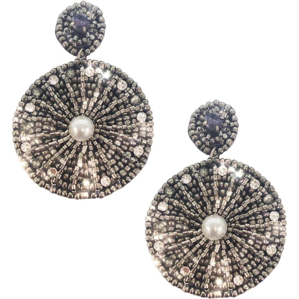 Bold silver earrings with a starburst pattern and playful "Danger" and cactus patch details.