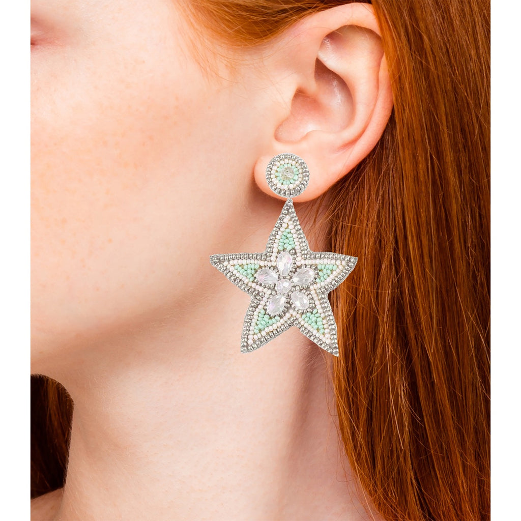 Fashion earrings with star design and rhinestones, detailed with mint-colored beading and a fun "Out of Office" patch.