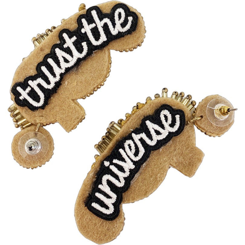 Glamorous seahorse earrings adorned with rhinestones and a "Trust the Universe" patch, lightweight and perfect for day or night wear.