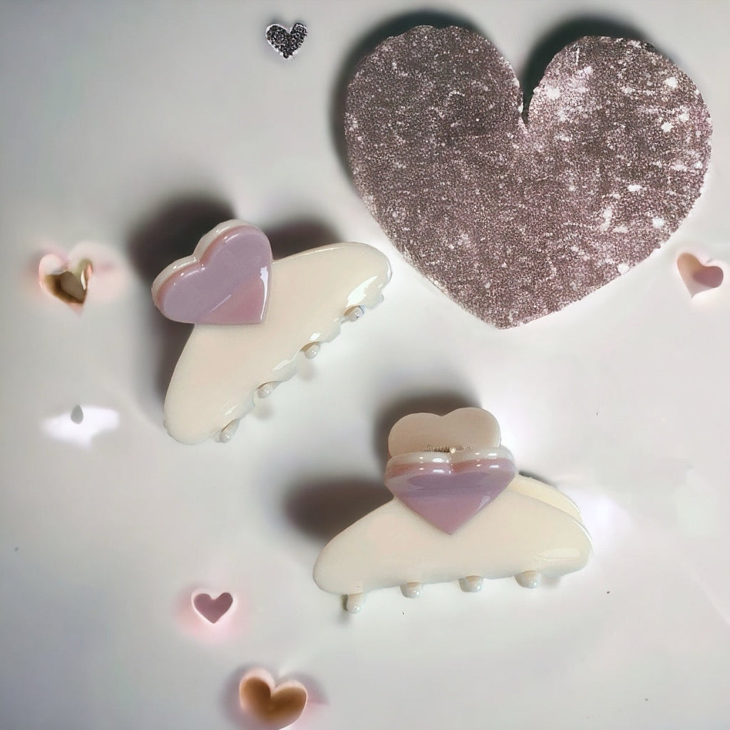 Heart-shaped pastel hair claw clips with glittery accents in pink and white, perfect for any hairstyle.