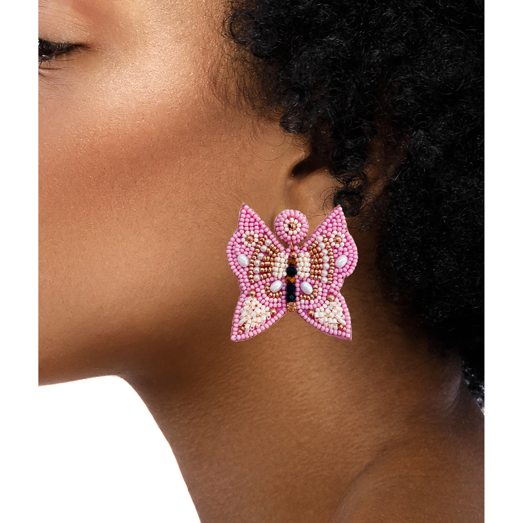 Handmade blush pink butterfly earrings with crystal embellishments and a "Coffee pls" design.