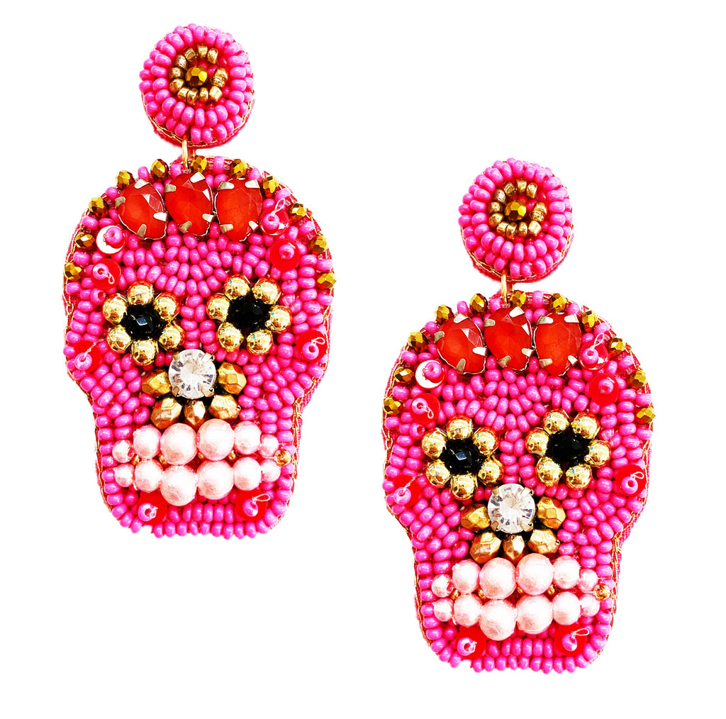 Bright and bold sugar skull earrings adorned with vibrant pink beads, gold accents, and pearl details—perfect for a playful, statement-making accessory.