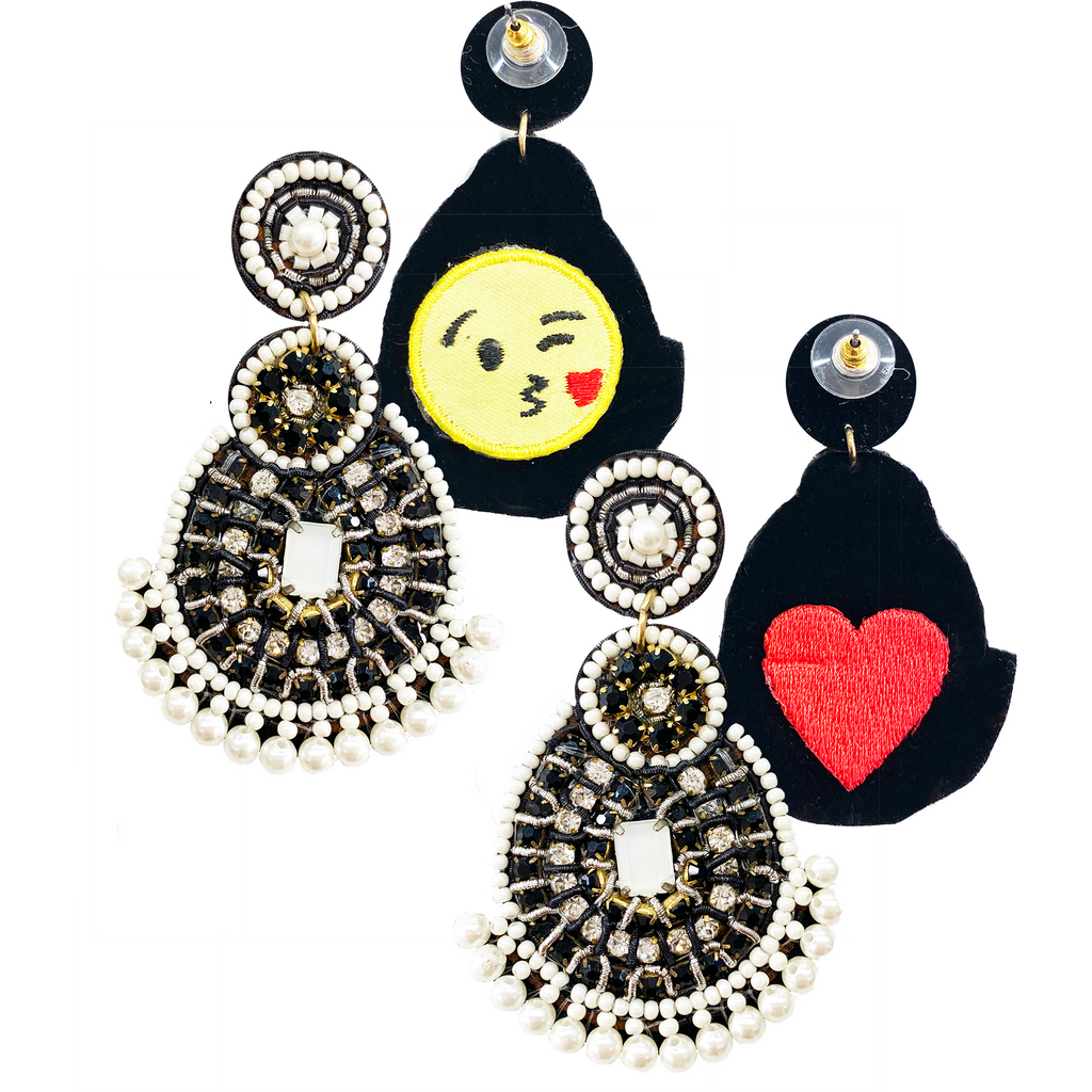 Statement silver earrings with detailed embellishments and a unique patch design.