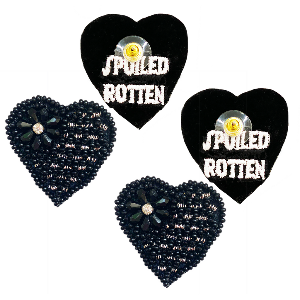 Black heart-shaped stud earrings featuring a bold "Spoiled Rotten" patch design.