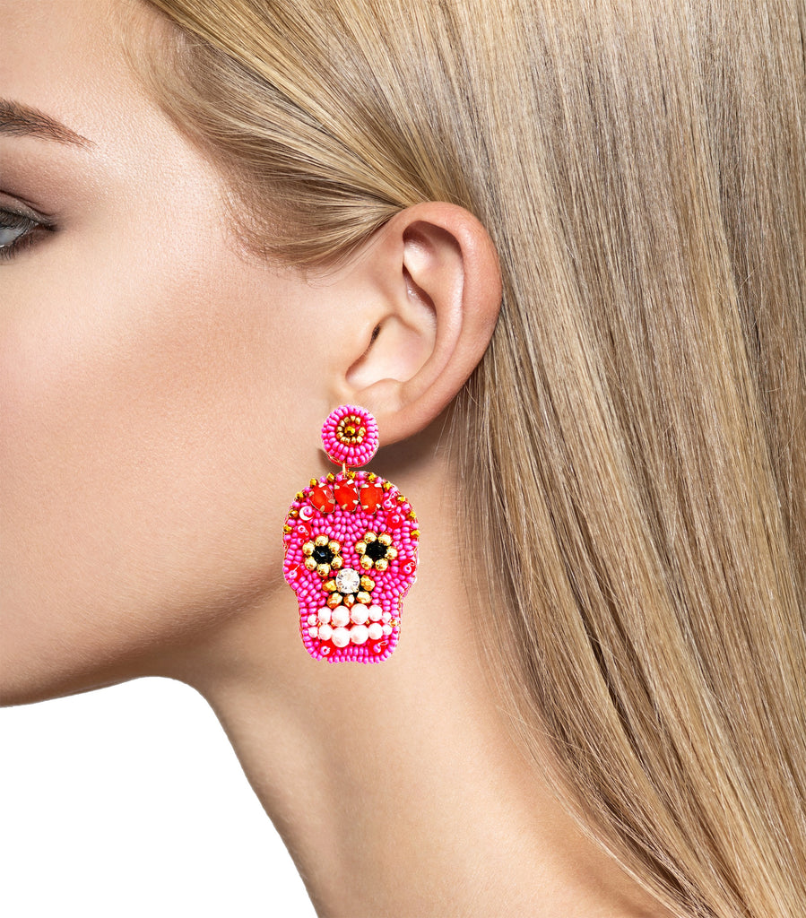 Bold and vibrant sugar skull earrings with intricate pink beadwork, gold accents, and pearl details—designed to make a playful yet elegant statement.